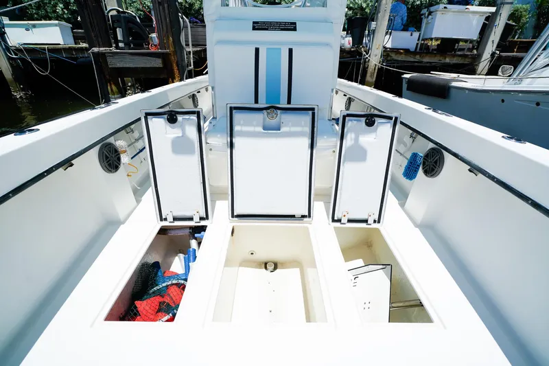 Slide: The Image of 2001 Whitewater 28 Open boat with open storage compartments at dock. - 22