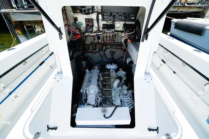 Slide: The Image of Engine compartment of a 2001 Whitewater 28 Open boat, showcasing wiring and components. - 23