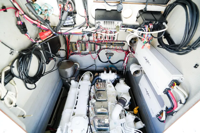Slide: The Image of Engine compartment of a 2001 Whitewater 28 Open boat, showcasing wiring and components. - 24