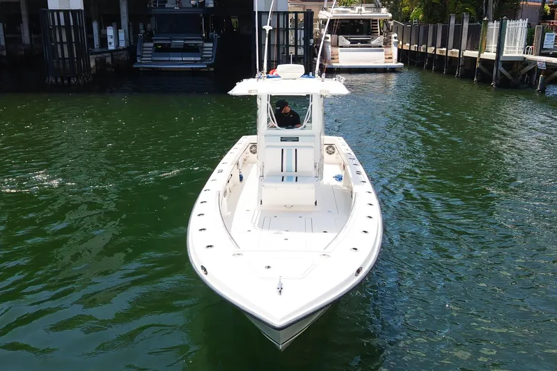 Slide: The Image of 2001 Whitewater 28 Open boat on calm water near a dock. - 25