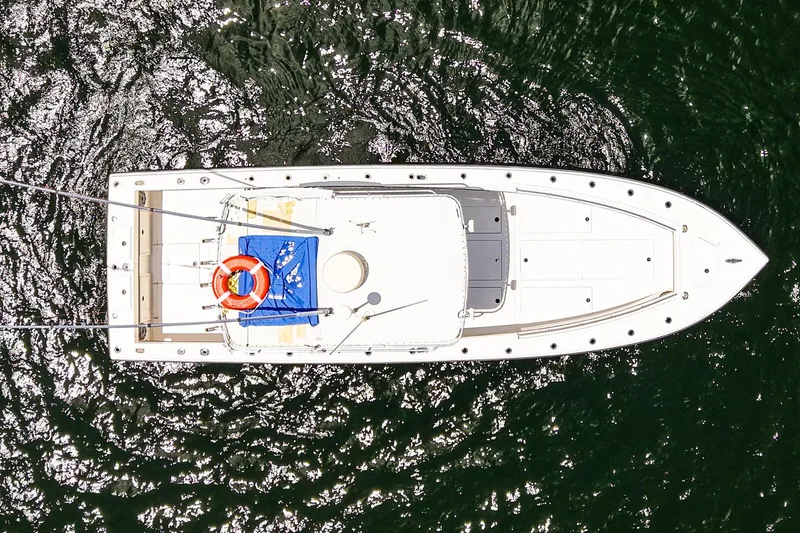 Slide: The Image of Aerial view of 2001 Whitewater 28 Open boat on shimmering water. - 3