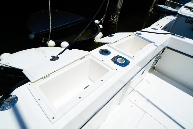 Slide: The Image of 2001 Whitewater 28 Open boat deck with storage compartments and cup holders. - 6