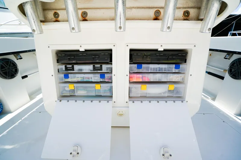 Slide: The Image of Tackle storage compartments on a 2001 Whitewater 28 Open boat, featuring organized fishing gear. - 7