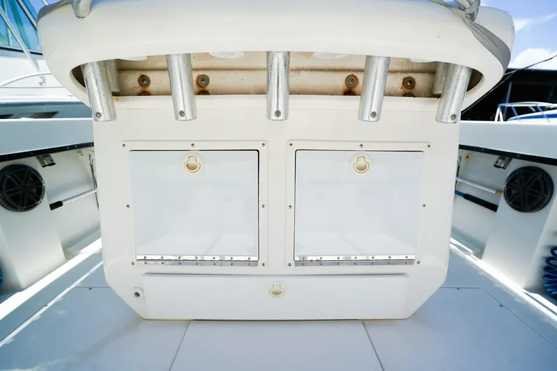 Slide: The Image of 2001 Whitewater 28 Open boat interior with storage compartments and rod holders. - 9