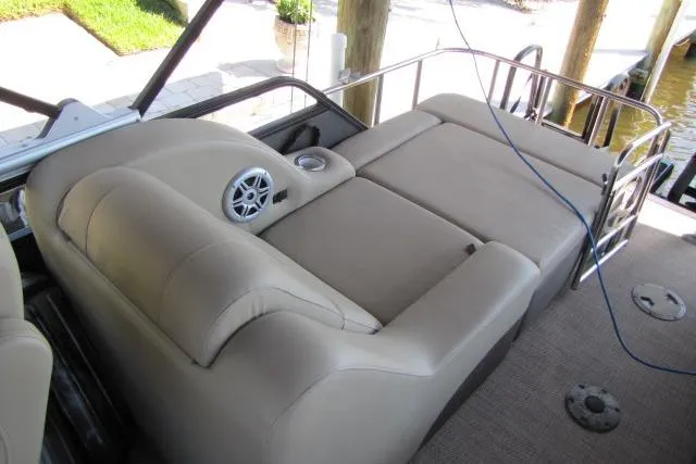 Slide: The Image of 2018 Regency 220 DL3 boat interior with beige seating and speaker system. - 11