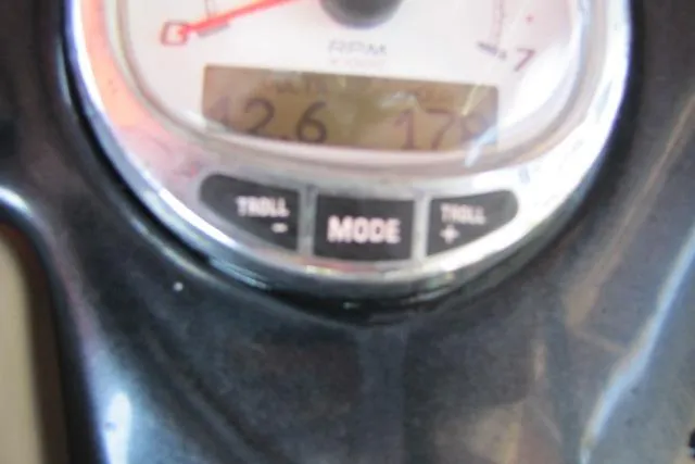 Slide: The Image of Close-up of a 2018 Regency 220 DL3 boat dashboard gauge displaying RPM and mode buttons. - 12