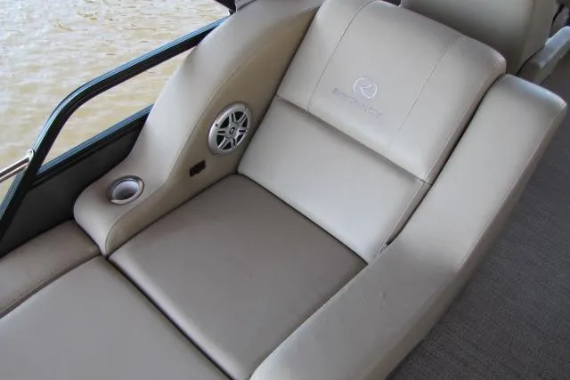 Slide: The Image of Luxurious seating on 2018 Regency 220 DL3 boat with speaker and cup holder. - 9
