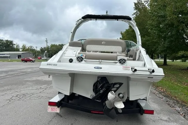 Slide: The Image of 2023 Crownline 260 SS boat on trailer, rear view, parked outdoors. - 2