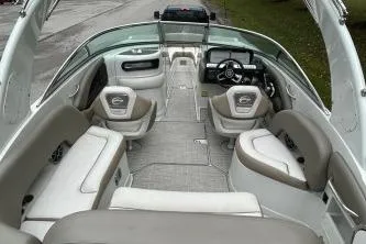 Slide: The Image of 2023 Crownline 260 SS boat interior with spacious seating and modern dashboard. - 4