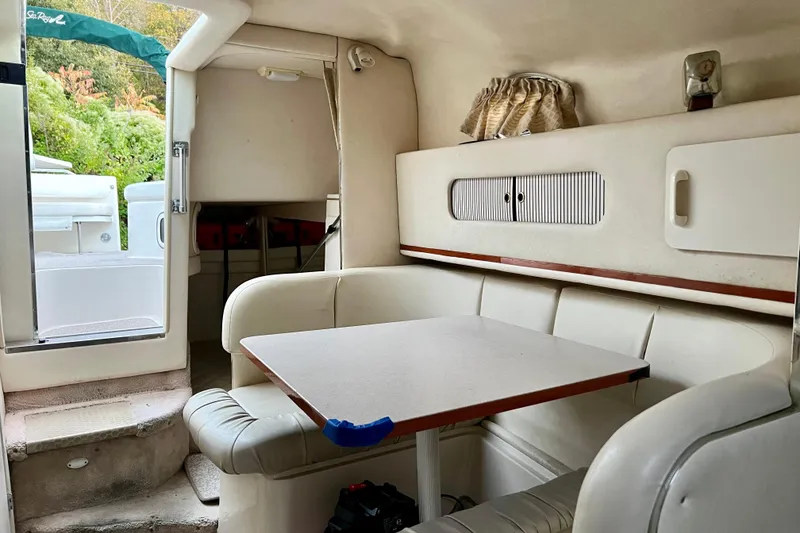 Slide: The Image of Interior of 2000 Sea Ray 270 Sundancer boat with cozy seating and table. - 14