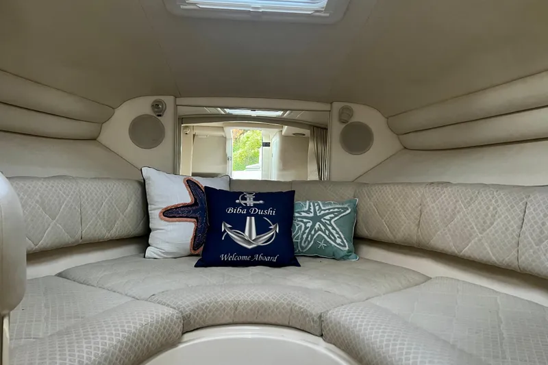 Slide: The Image of Interior of 2000 Sea Ray 270 Sundancer with cozy seating and decorative pillows. - 16