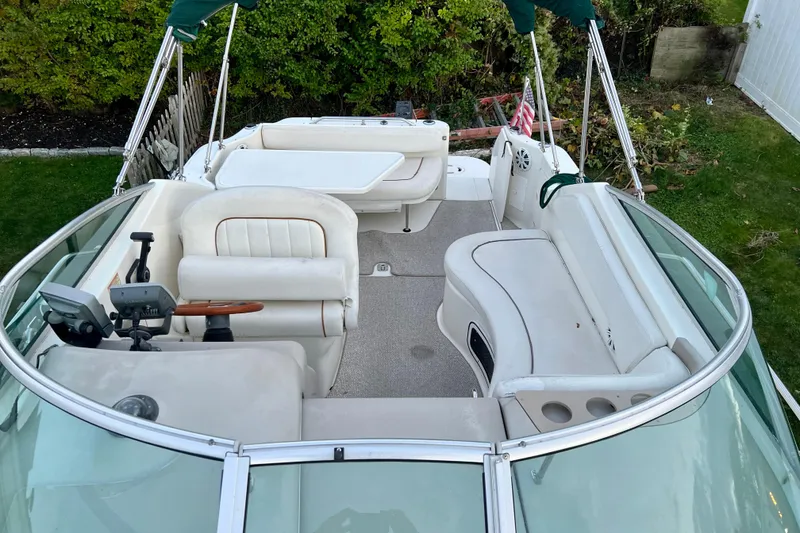 Slide: The Image of 2000 Sea Ray 270 Sundancer boat interior with seating and steering wheel. - 9