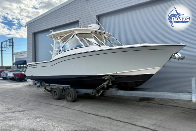 Slide: The Image of 2021 Grady-White Freedom 325 boat on trailer outside a warehouse. - 0