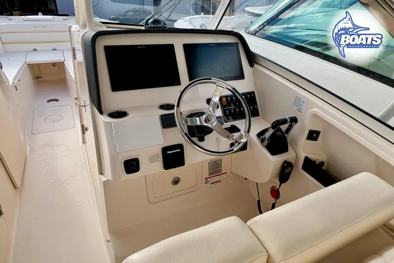 Slide: The Image of 2021 Grady-White Freedom 325 boat cockpit with steering wheel and control panel. - 10