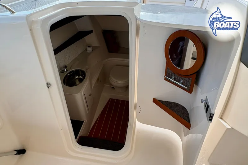 Slide: The Image of 2021 Grady-White Freedom 325 boat interior with sink, toilet, and mirror. - 11