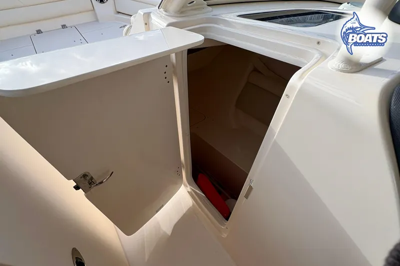 Slide: The Image of 2021 Grady-White Freedom 325 boat storage compartment with open door. - 13