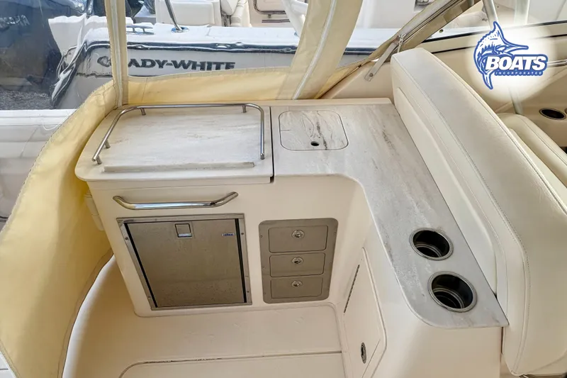 Slide: The Image of 2021 Grady-White Freedom 325 boat interior with kitchenette and seating area. - 15
