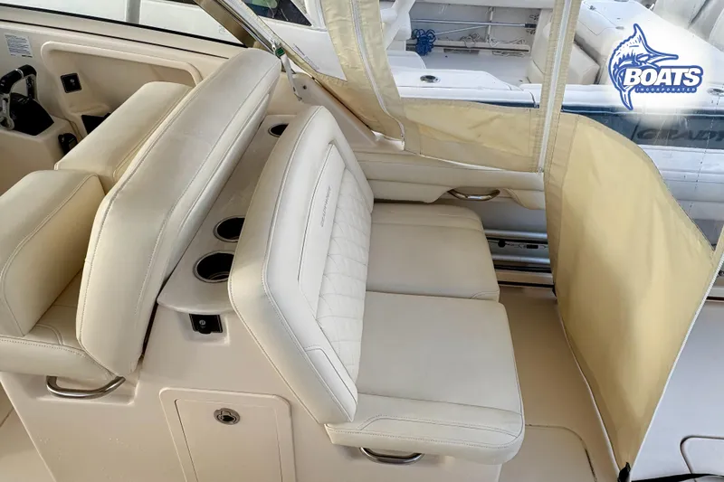 Slide: The Image of 2021 Grady-White Freedom 325 boat interior with beige seating and cup holders. - 17