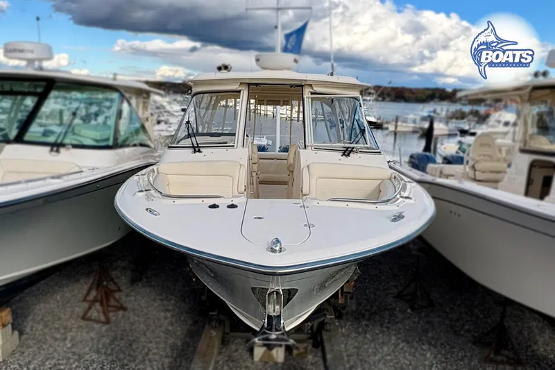 Slide: The Image of 2021 Grady-White Freedom 325 boat docked at marina under cloudy sky. - 7