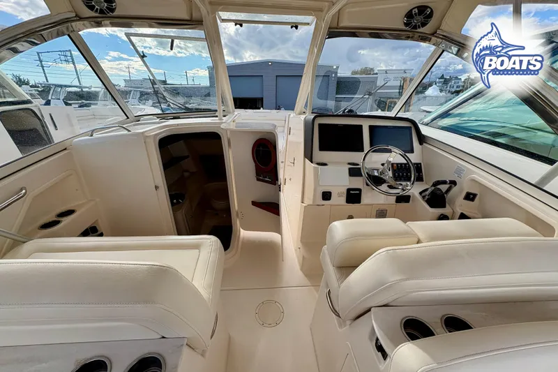 Slide: The Image of 2021 Grady-White Freedom 325 boat interior with helm, seating, and controls. - 8