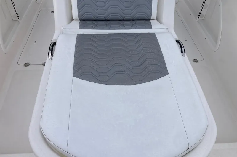 Slide: The Image of 2021 Twin Vee 280 GFX CC boat seat with gray cushioned design. - 11