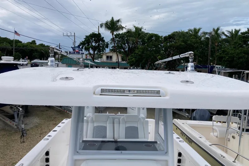 Slide: The Image of 2021 Twin Vee 280 GFX CC boat with wet deck, parked near Blue Fin Inn. - 12