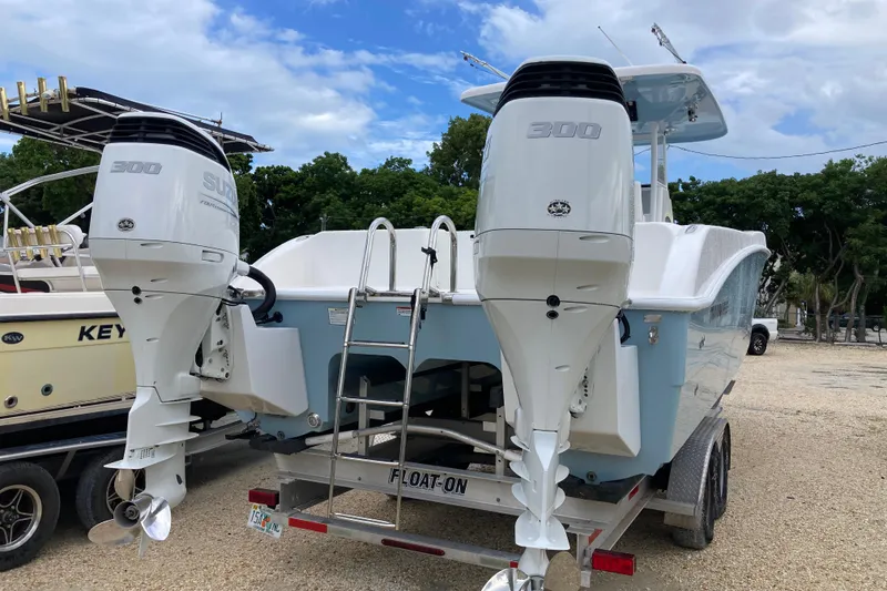 Slide: The Image of 2021 Twin Vee 280 GFX CC boat with dual Suzuki 300 engines on trailer. - 3