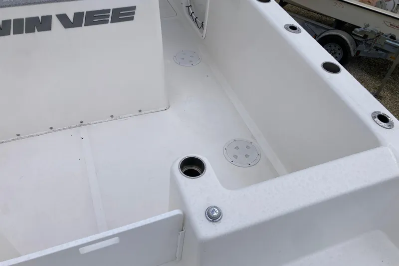 Slide: The Image of 2021 Twin Vee 280 GFX CC boat interior, featuring rod holders and storage compartments. - 5