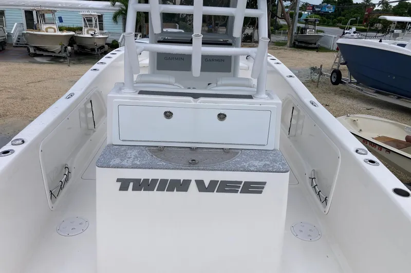 Slide: The Image of 2021 Twin Vee 280 GFX CC boat interior with Garmin equipment, docked outdoors. - 6