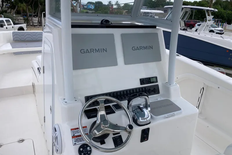 Slide: The Image of 2021 Twin Vee 280 GFX CC boat dashboard with Garmin navigation displays. - 7