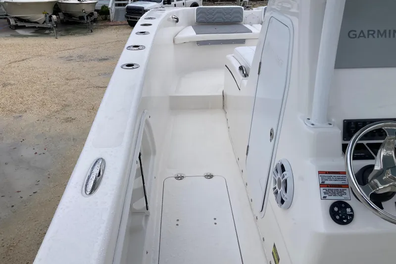 Slide: The Image of 2021 Twin Vee 280 GFX CC boat interior with steering wheel and seating area. - 8