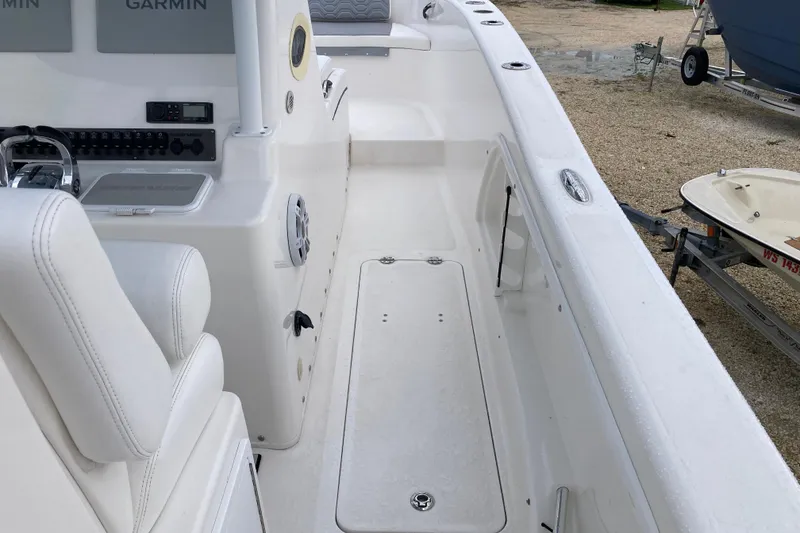 Slide: The Image of 2021 Twin Vee 280 GFX CC boat interior with white seating and control panel. - 9