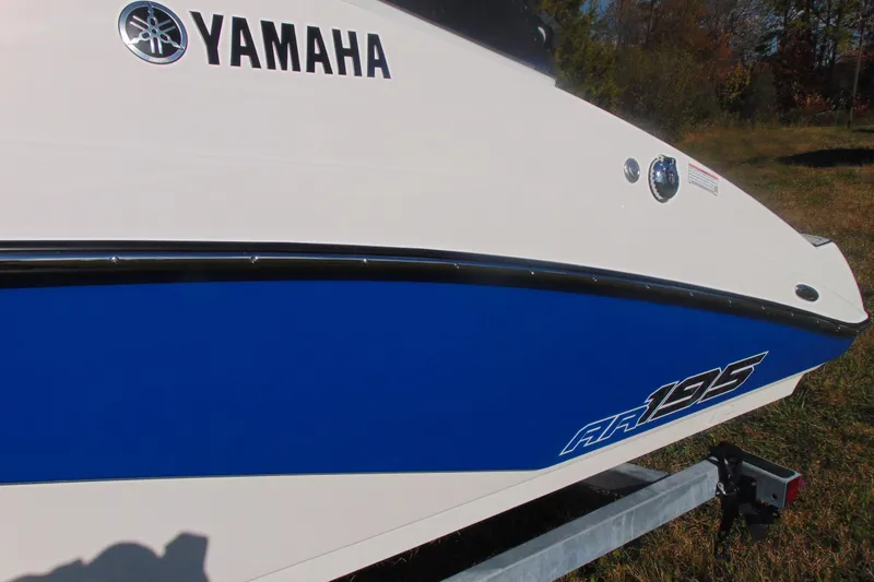 Slide: The Image of 2026 Yamaha AR195 boat side view with blue and white design. - 3