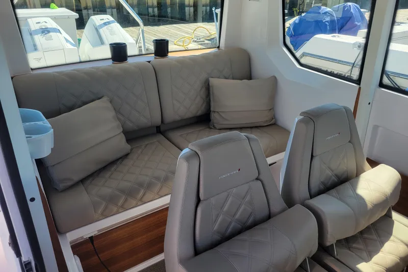 Slide: The Image of Interior of 2023 Axopar 28 Cabin with plush seating and modern design. - 14