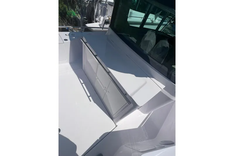 Slide: The Image of 2023 Axopar 28 Cabin Wet Bar with sleek white design and modern features. - 5