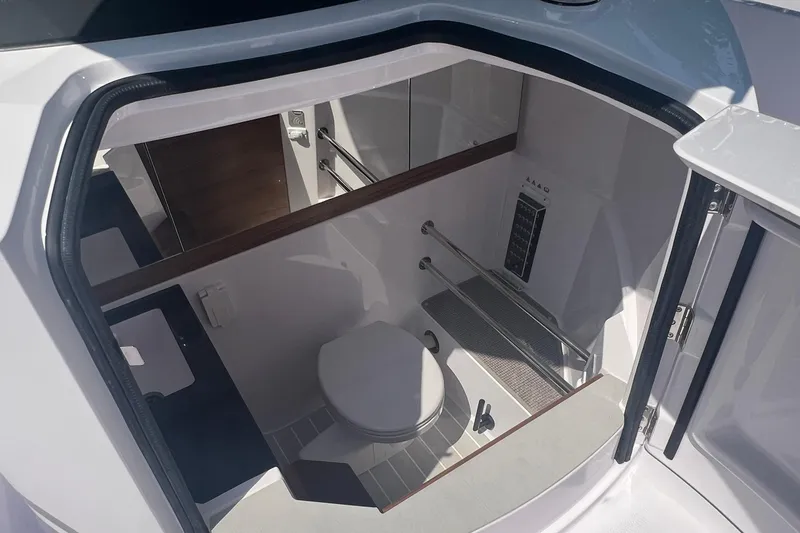Slide: The Image of 2023 Axopar 28 Cabin Wet Bar interior with modern bathroom amenities. - 7
