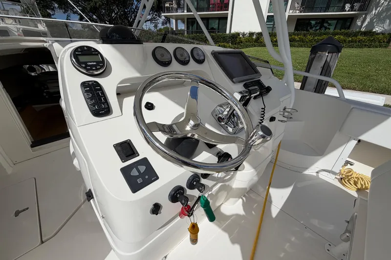 Slide: The Image of 2008 Intrepid 350 Center Console boat dashboard with steering wheel and controls. - 16