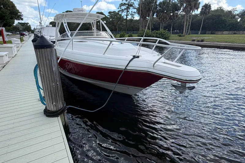 Slide: The Image of 2008 Intrepid 350 Center Console boat docked by a wooden pier. - 2