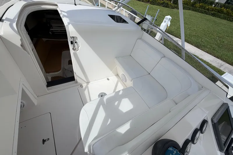 Slide: The Image of 2008 Intrepid 350 Center Console boat interior with white seating and open cabin door. - 20