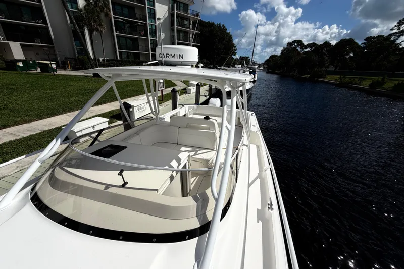 Slide: The Image of 2008 Intrepid 350 Center Console boat docked by a canal under a sunny sky. - 23