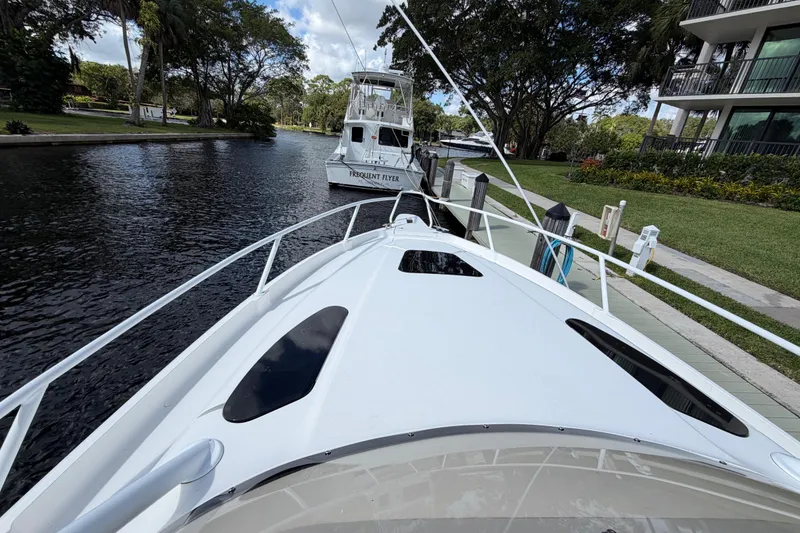 Slide: The Image of 2008 Intrepid 350 Center Console docked on a serene waterway with lush greenery. - 25
