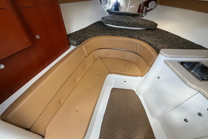 Slide: The Image of 2008 Intrepid 350 Center Console cabin interior with seating, bed, and kitchenette. - 32