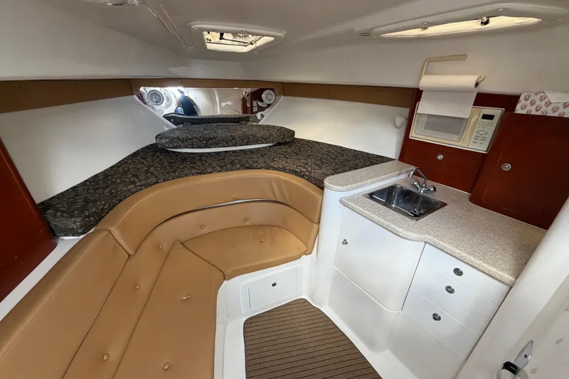 Slide: The Image of Interior of 2008 Intrepid 350 Center Console with bed, kitchenette, and seating area. - 34