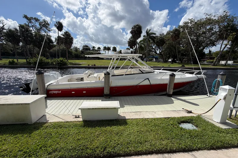 Slide: The Image of 2008 Intrepid 350 Center Console boat docked by a scenic waterfront. - 4