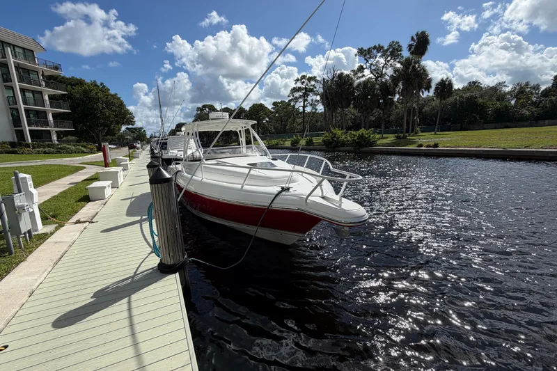Slide: The Image of 2008 Intrepid 350 Center Console boat docked by a scenic waterfront. - 5