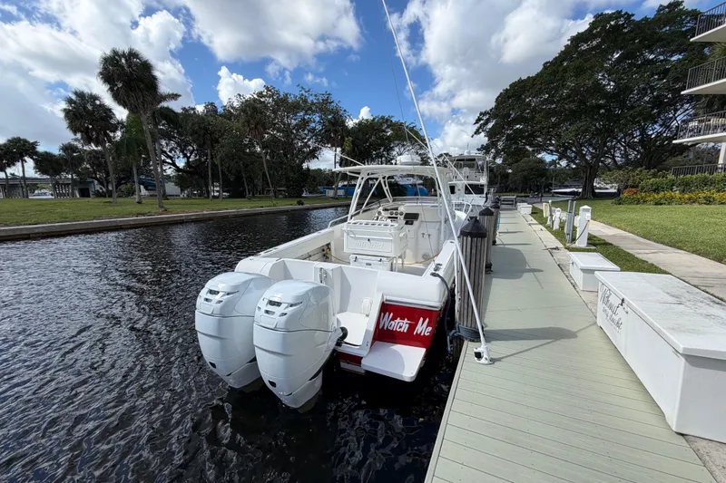 Slide: The Image of 2008 Intrepid 350 Center Console boat docked by a scenic waterfront. - 6