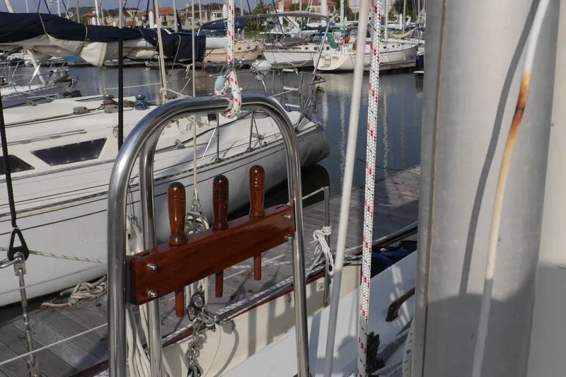 Slide: The Image of 1976 Westsail 32 sailboat docked in marina, featuring rigging and cockpit cover. - 10