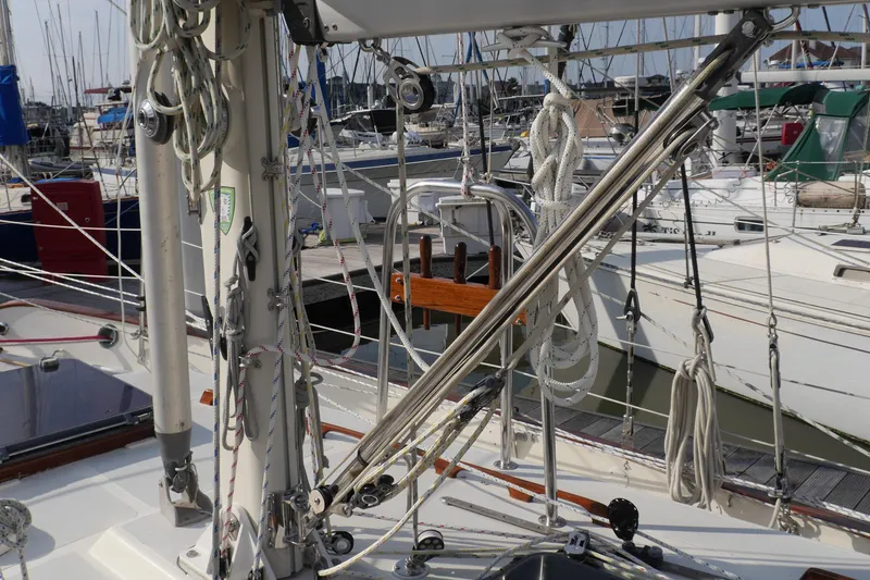Slide: The Image of 1976 Westsail 32 sailboat with solar panel and wind vane at marina dock. - 12