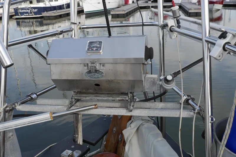 Slide: The Image of 1976 Westsail 32 sailboat deck with wooden belaying pins and rigging. - 16