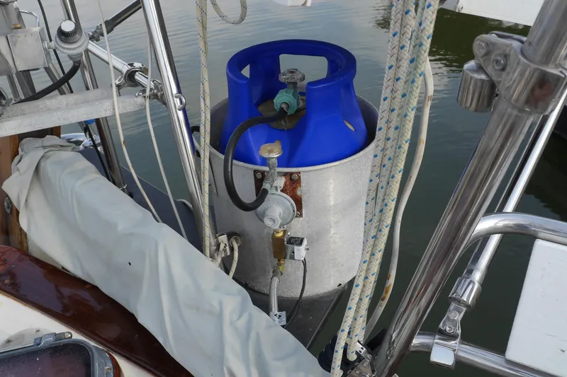 Slide: The Image of 1976 Westsail 32 sailboat deck with rigging and marina background. - 17